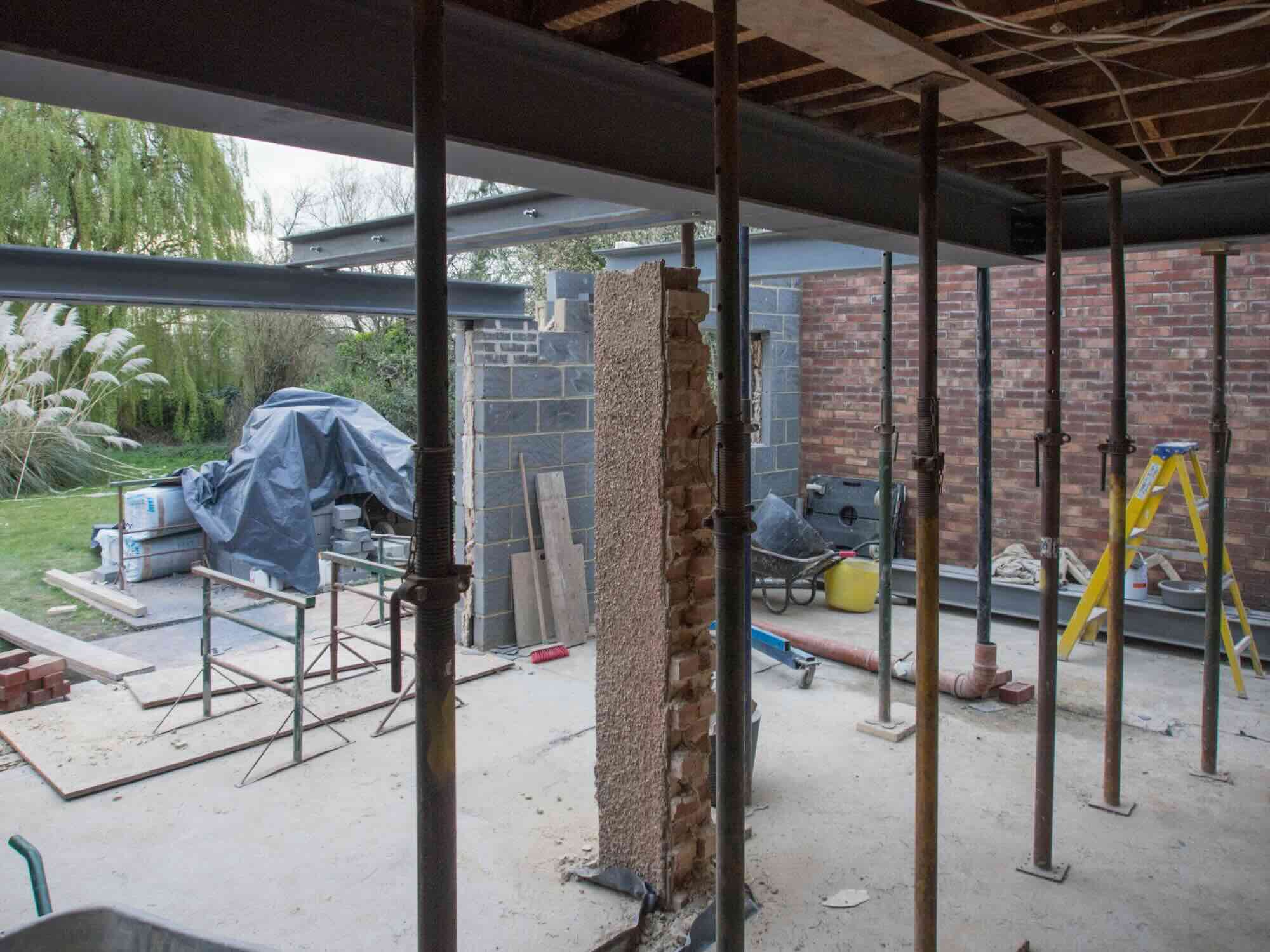 Surveyor Discussing Party Wall Regulations with Homeowner for Two-Story Extension